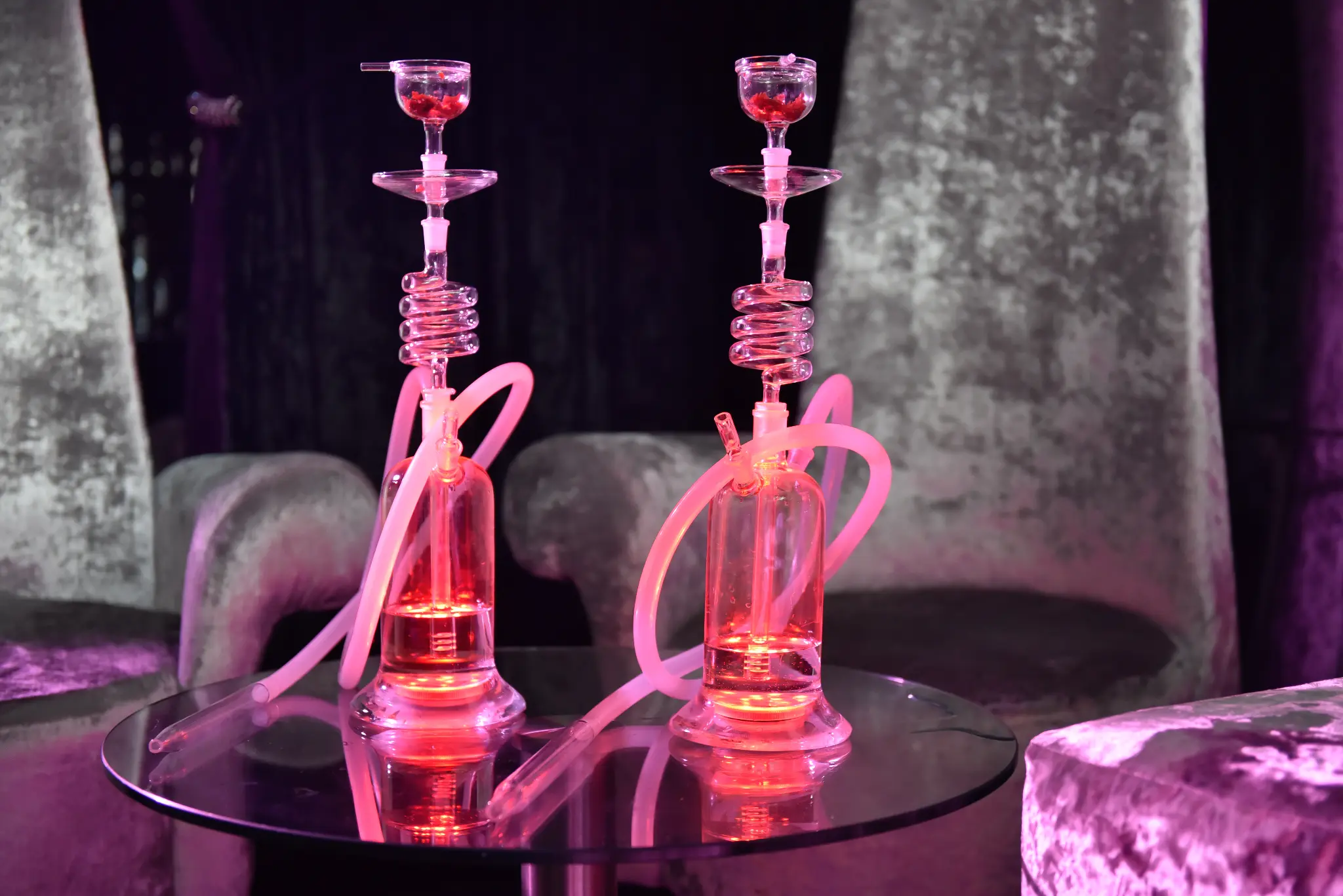 Pink LED shisha pipes at elegant event with sophisticated ambiance